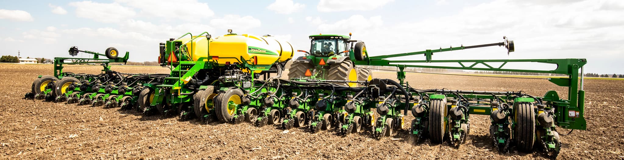 Tractor pulling planter through a tilled field